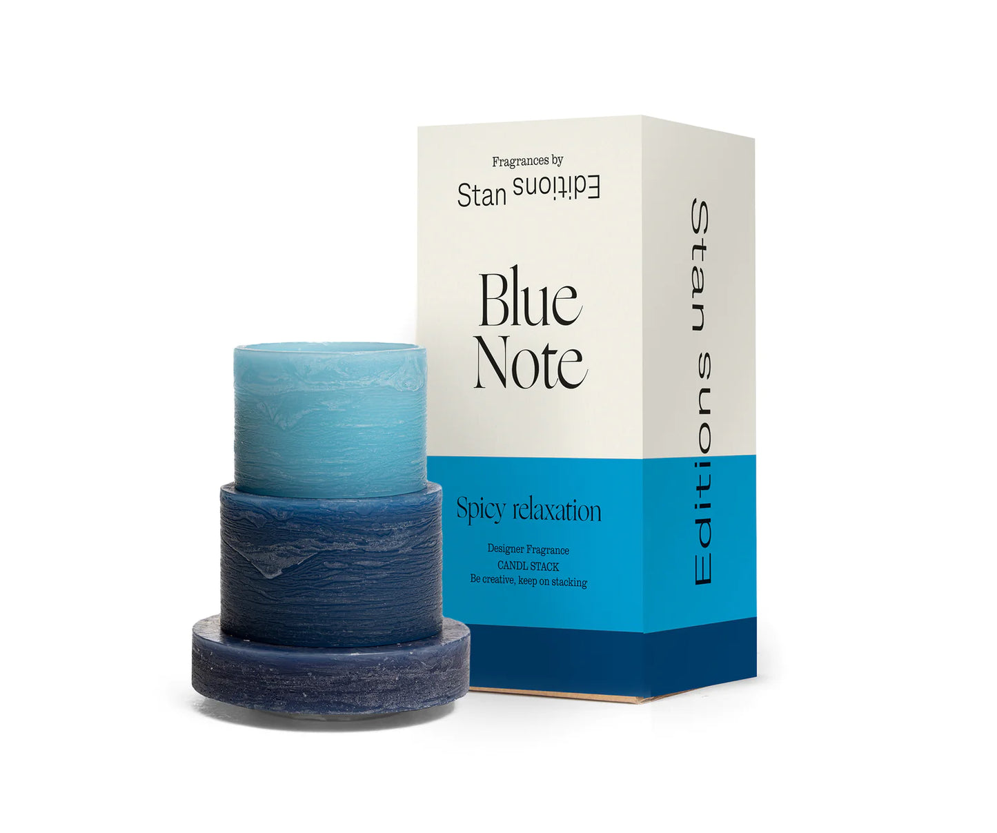 A blue 3-layered stacked candle next to the candle's box packaging.