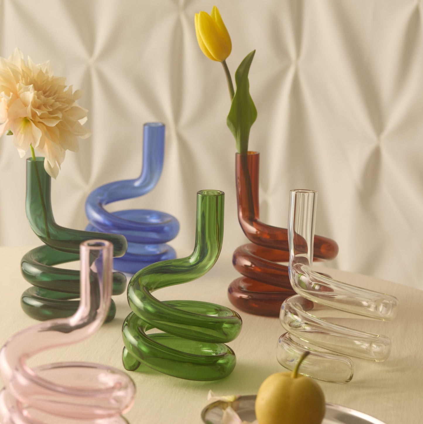Colourful spiral vases on a neutral background