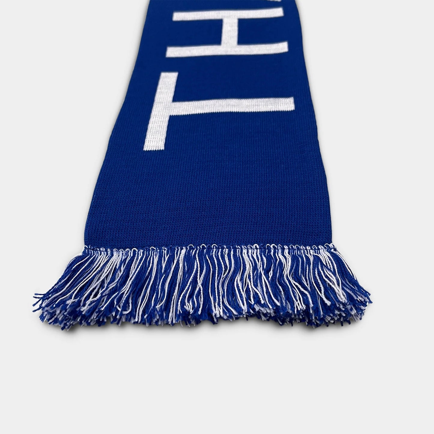 Blue scarf with white lettering on a light gray background