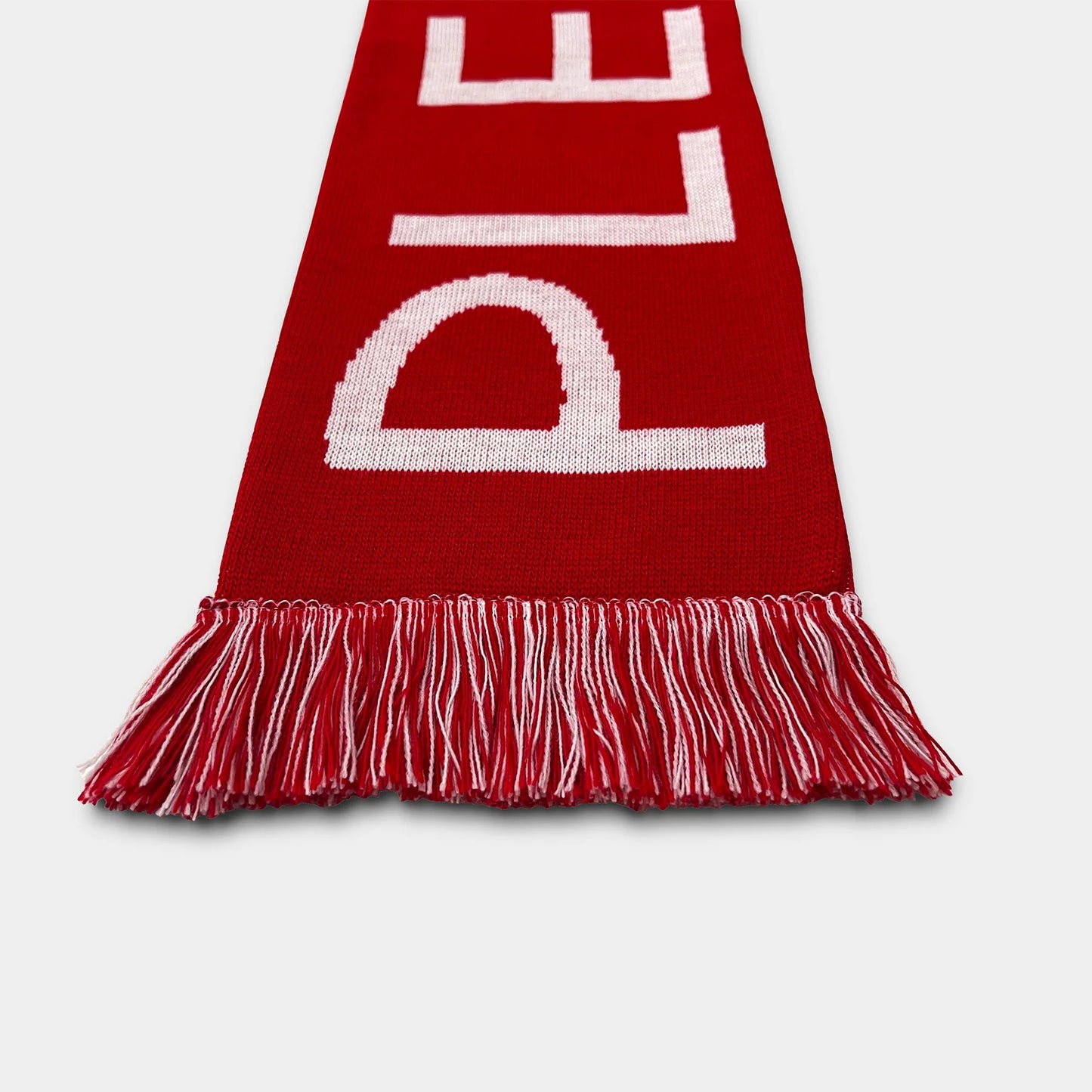 Red scarf with white letters on a light gray background