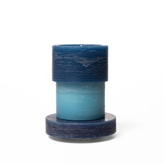 A blue 3-layered stacked candle