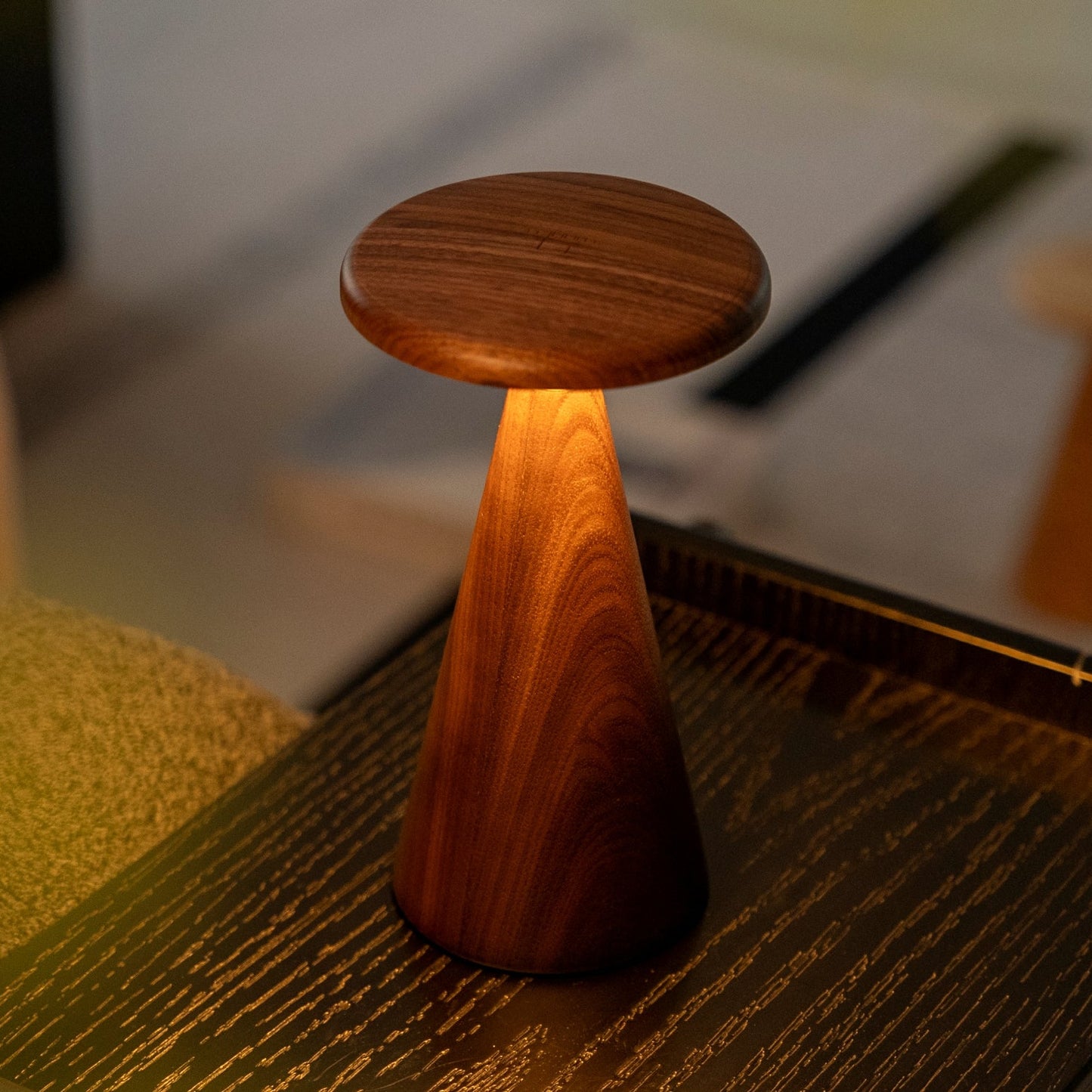 Wooden light with a circular top on a textured surface