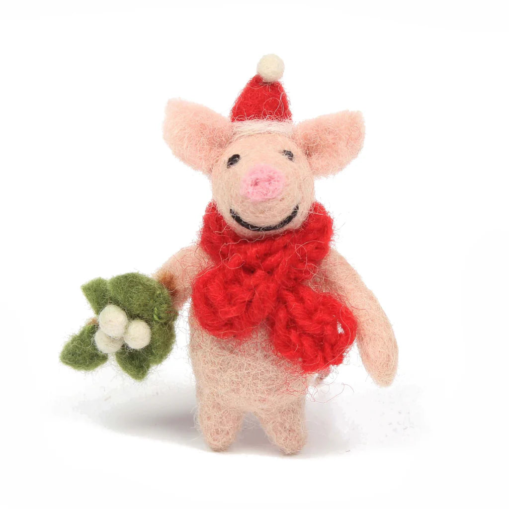 Felt piglet decoration adorned with a knitted red scarf, a santa hat, holding mistletoe.