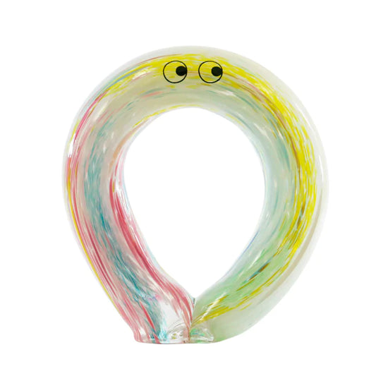 An oval shaped glass figurine with painted eyes