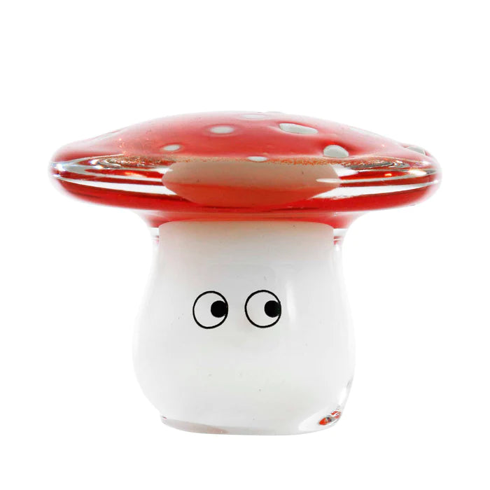 A glass, flat mushroom-shaped figurine with painted eyes