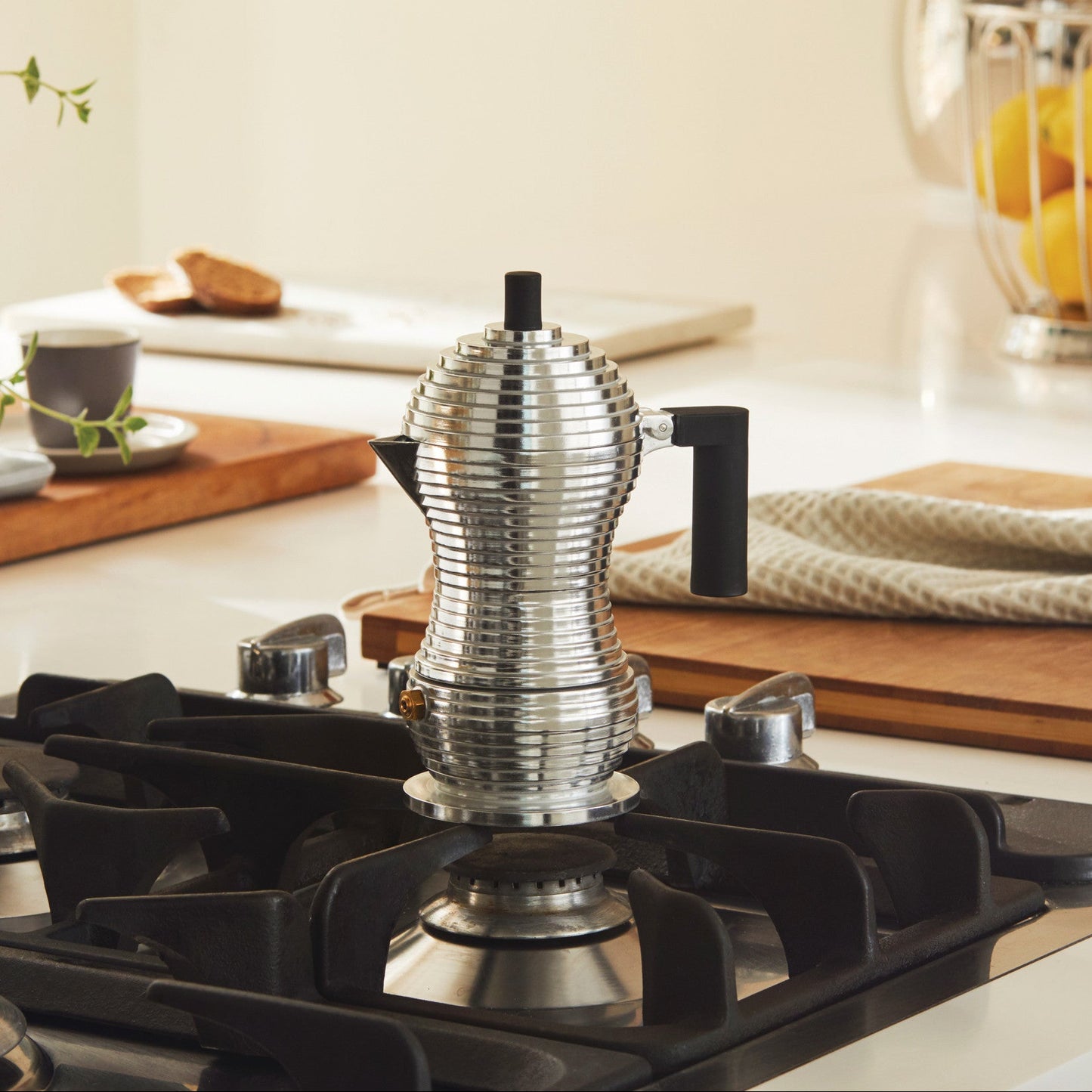Silver percolator on a stove with a kitchen background