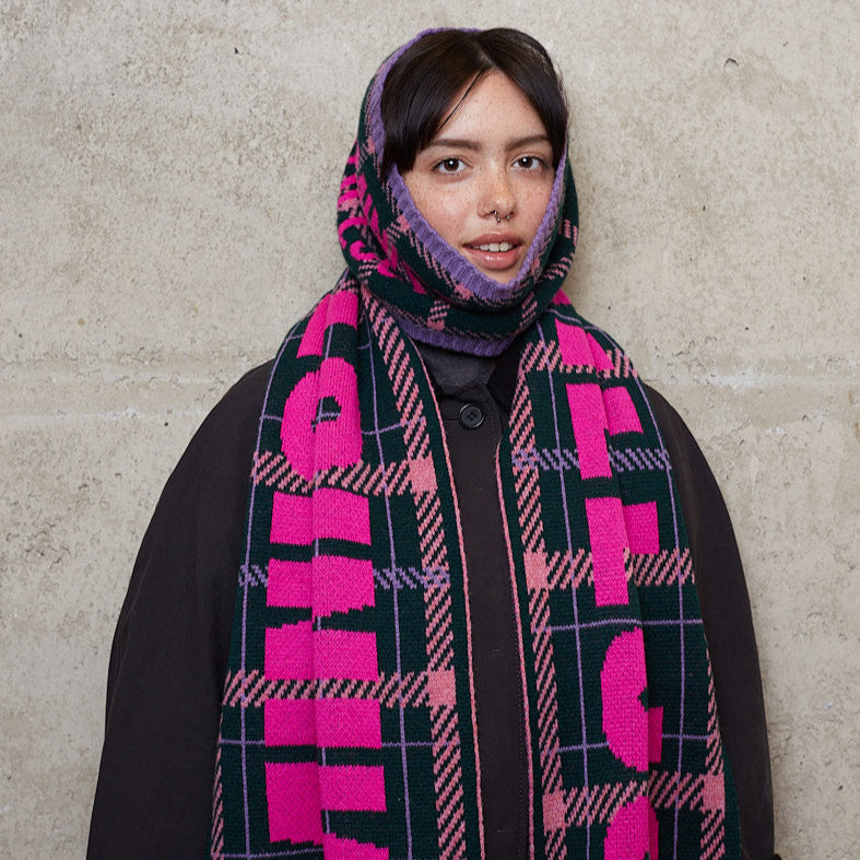 Model wearing a black & beech scarf wrapped around her head and neck.