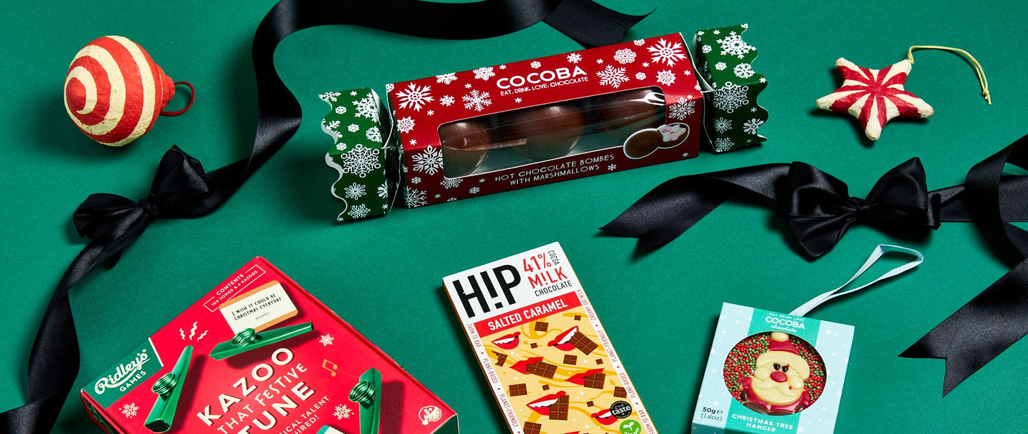 Assorted Christmas-themed products including a Kazoo, candy, and decorative items on a green background.