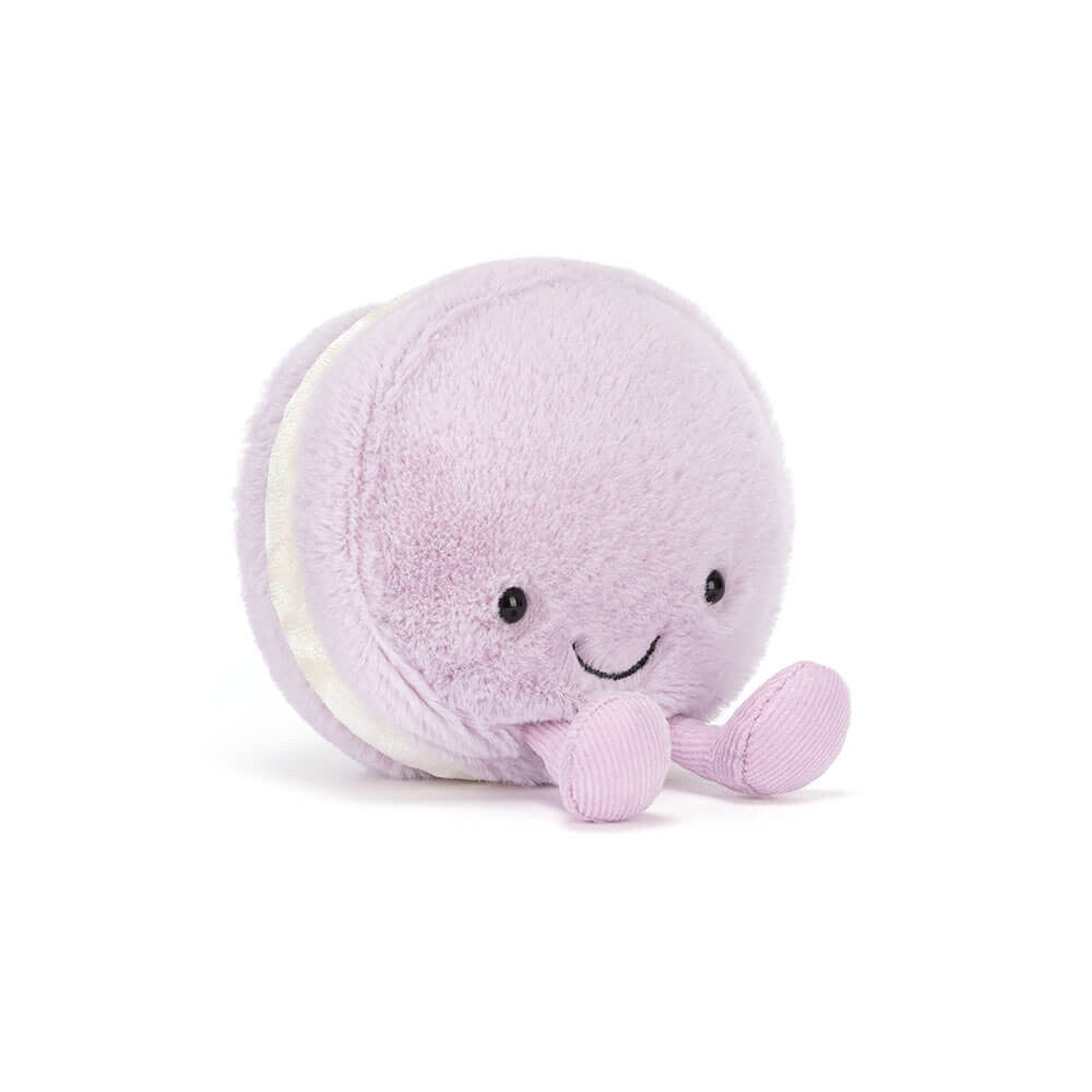 Purple plush toy macaron with a happy face on a white background