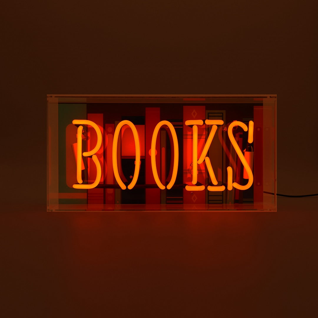 Neon sign with the word 'BOOKS' on a dark background