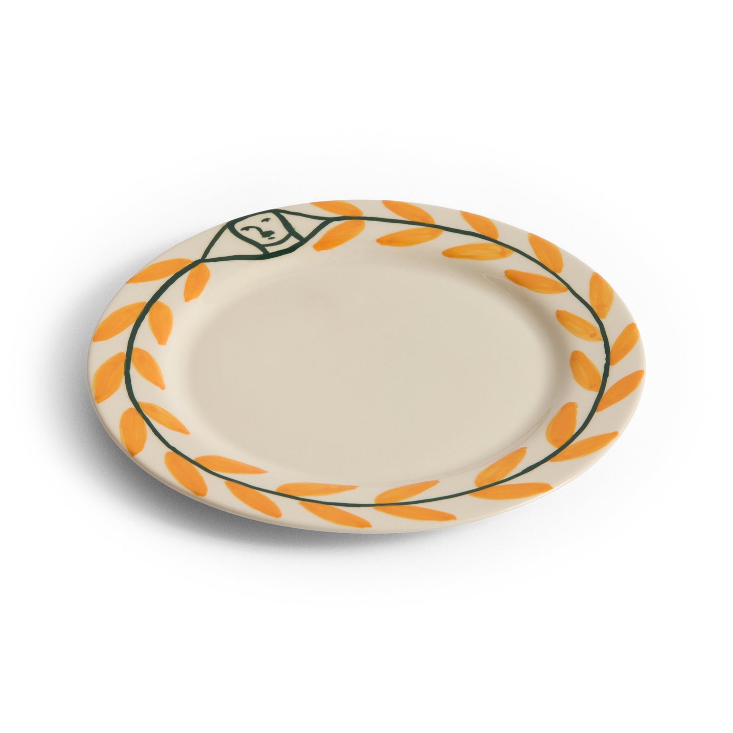 Ceramic plate with orange leaf pattern on a white background