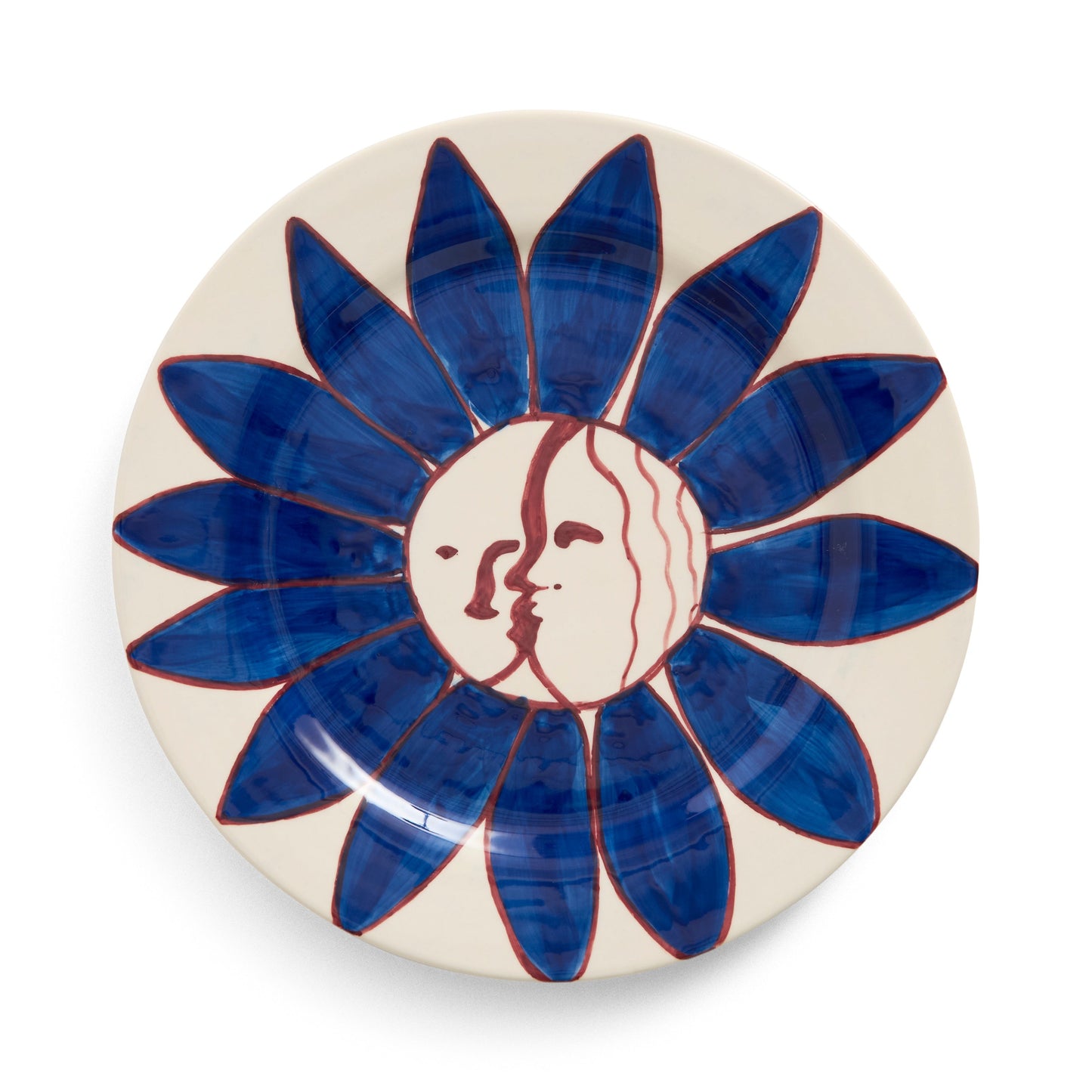 Ceramic plate with blue floral design and face emblem on a white background