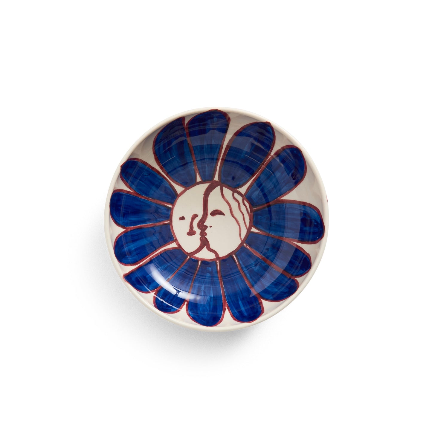 Ceramic dish with blue floral design and face emblem on a white background