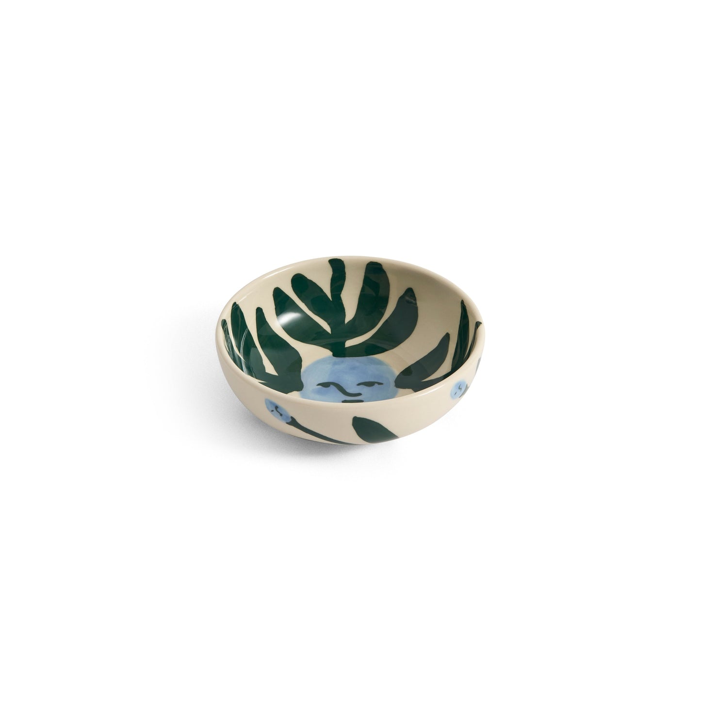 Small ceramic bowl with leaf pattern on a white background