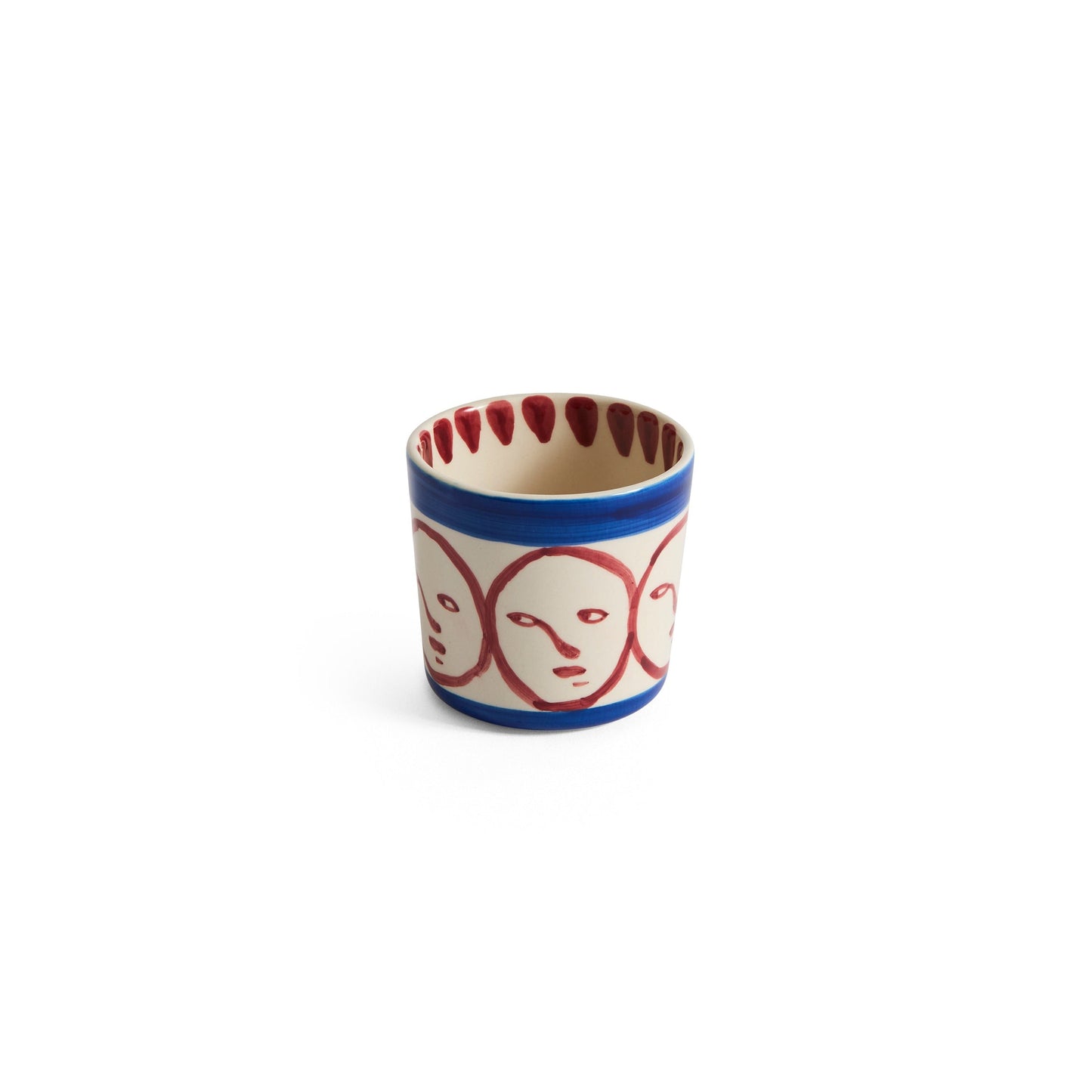 Small cup with face design on a white background