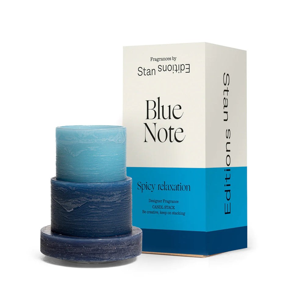 
                      
                        A blue 3-layered stacked candle next to the candle's box packaging.
                      
                    