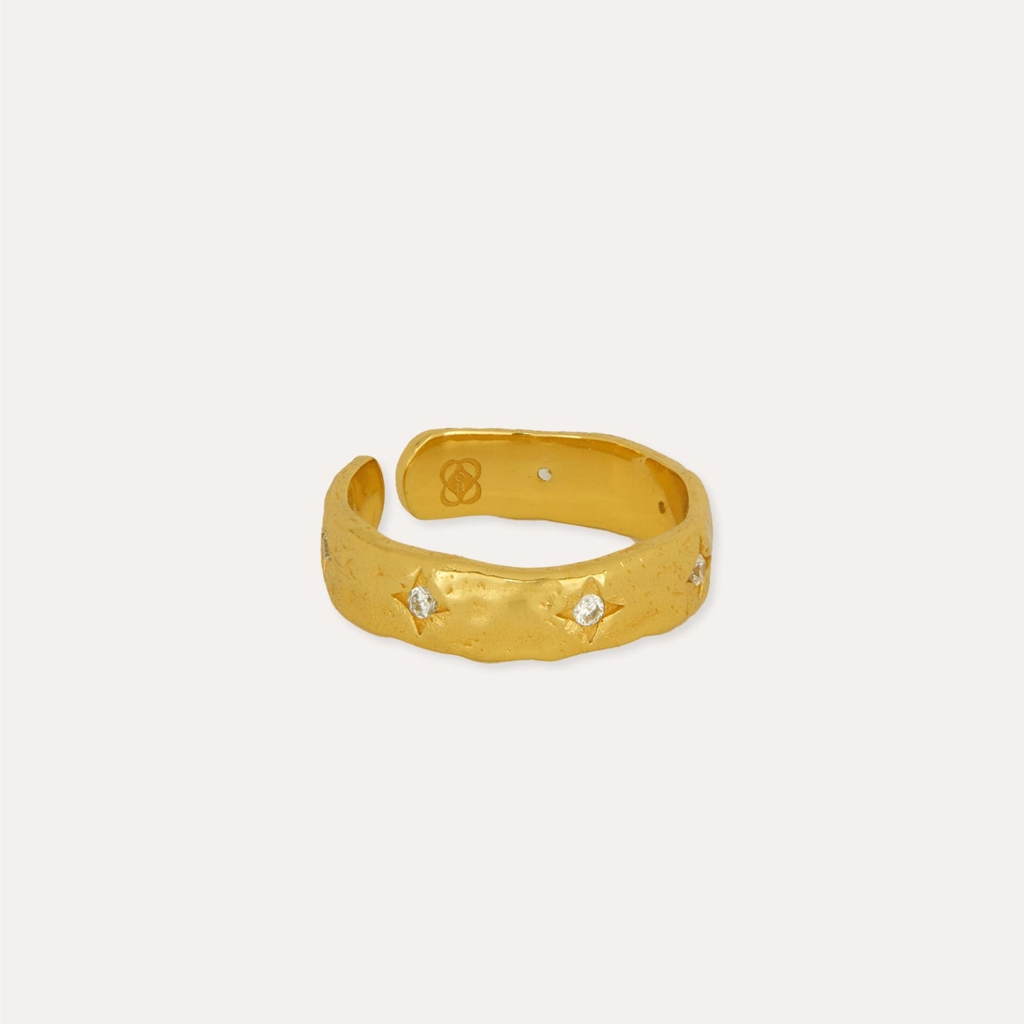 Gold ring with small stones on a white background