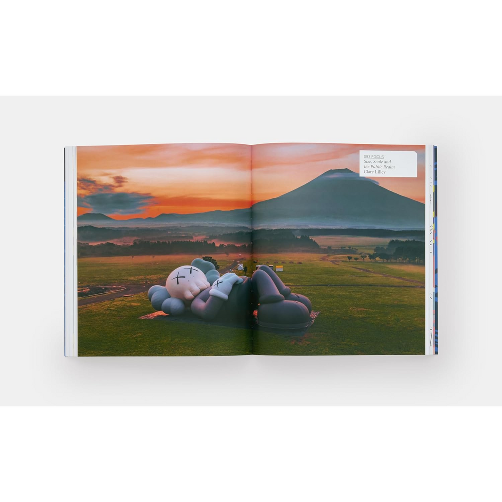 
                      
                        Internal double page spread with KAWS character asleep under a sunset.
                      
                    