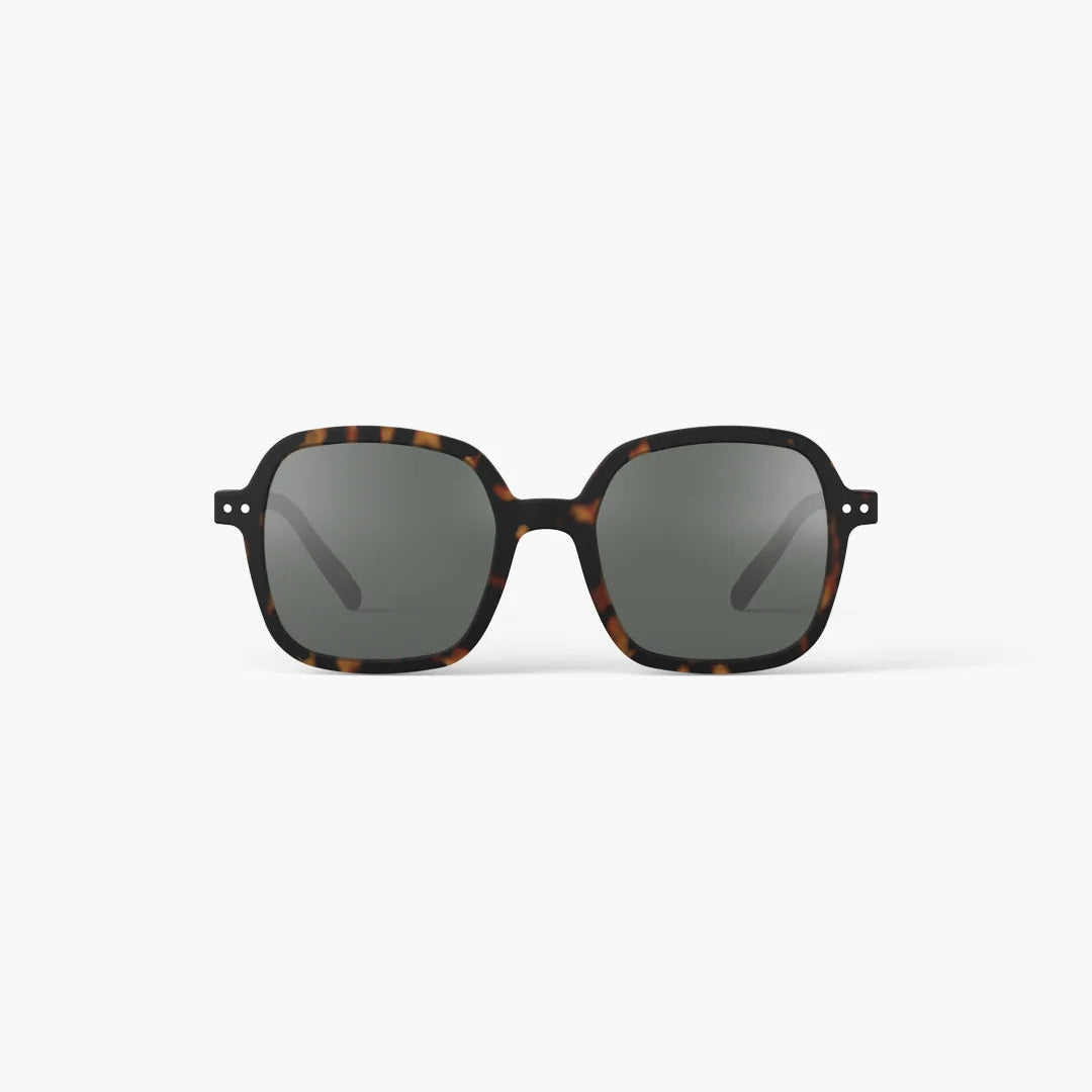 Sunglasses with tortoiseshell frame and dark lenses on a white background