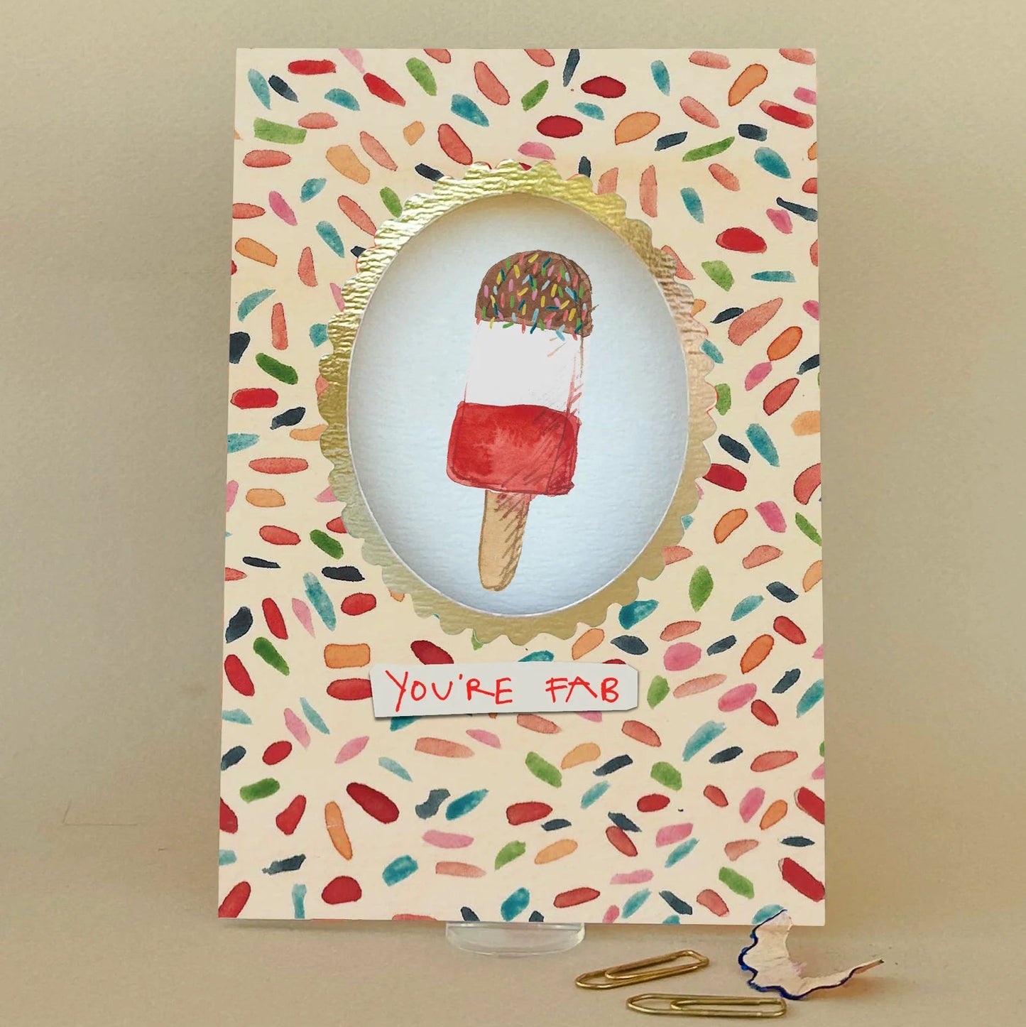 Card with ice cream illustration and colourful pattern on a beige background