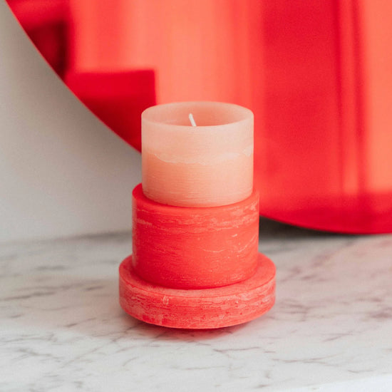 A red and pink 3-layered stacked candle 