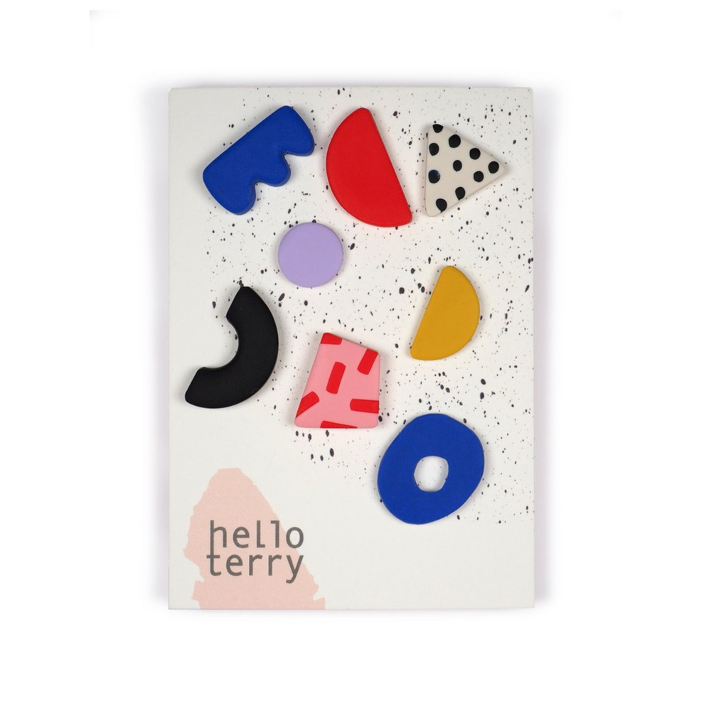 
                      
                        Multi-shaped and coloured mis-matched earrings by Hello Terry attached to a flat card.
                      
                    