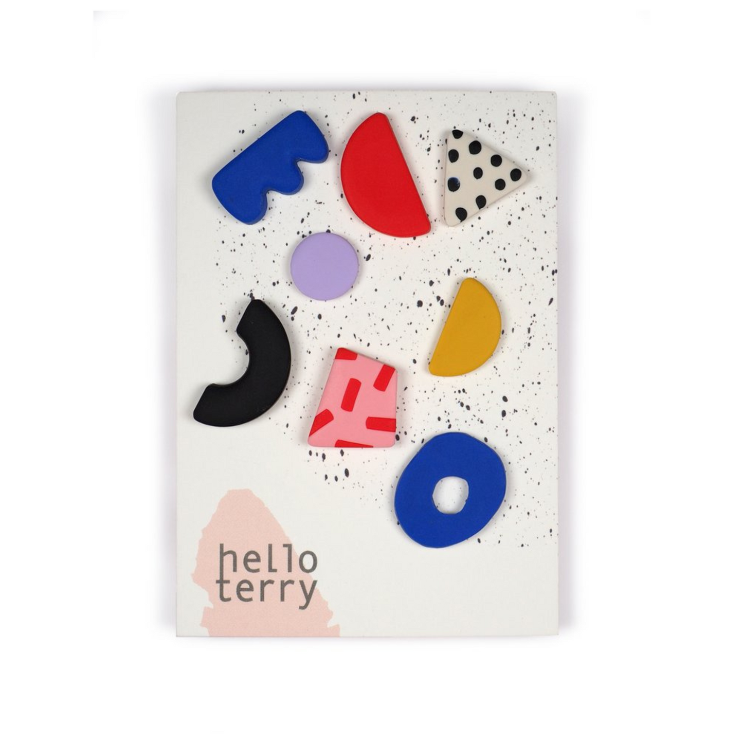 Multi-shaped and coloured mis-matched earrings by Hello Terry attached to a flat card.