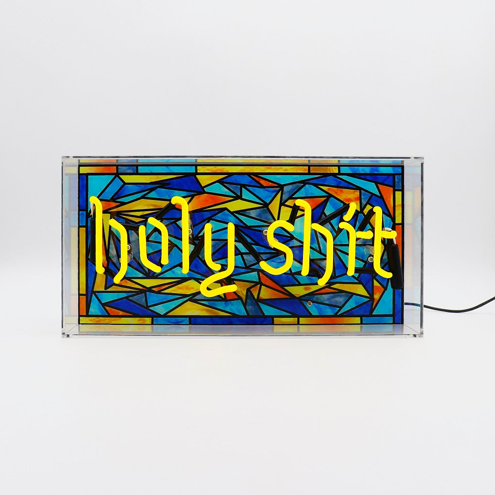 Stained glass-style sign with 'Holy Shit' text on a white background