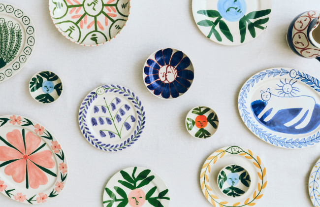 An image of different plates and bowls scattered around on a flat surface.