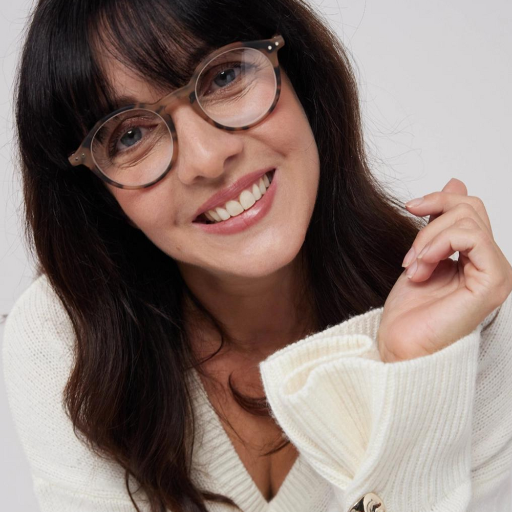 
                      
                        A female with brunette hair smiling, she is wearing the IZIPIZI Iconic Reading Glasses in the colour tortoiseshell.
                      
                    