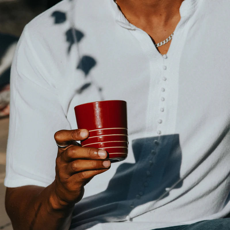 Person holding a red cup with a blurred background