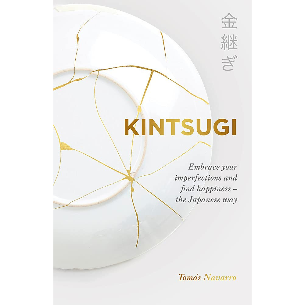 Kintsugi: Embrace your imperfections and find happiness book front cover showing a white ceramic plate repaired by the Kintsugi method.