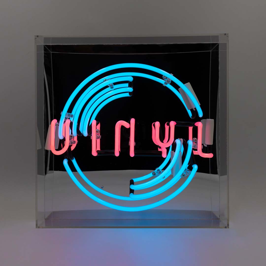 Neon sign with 'Vinyl' in pink letters and blue curved lights.