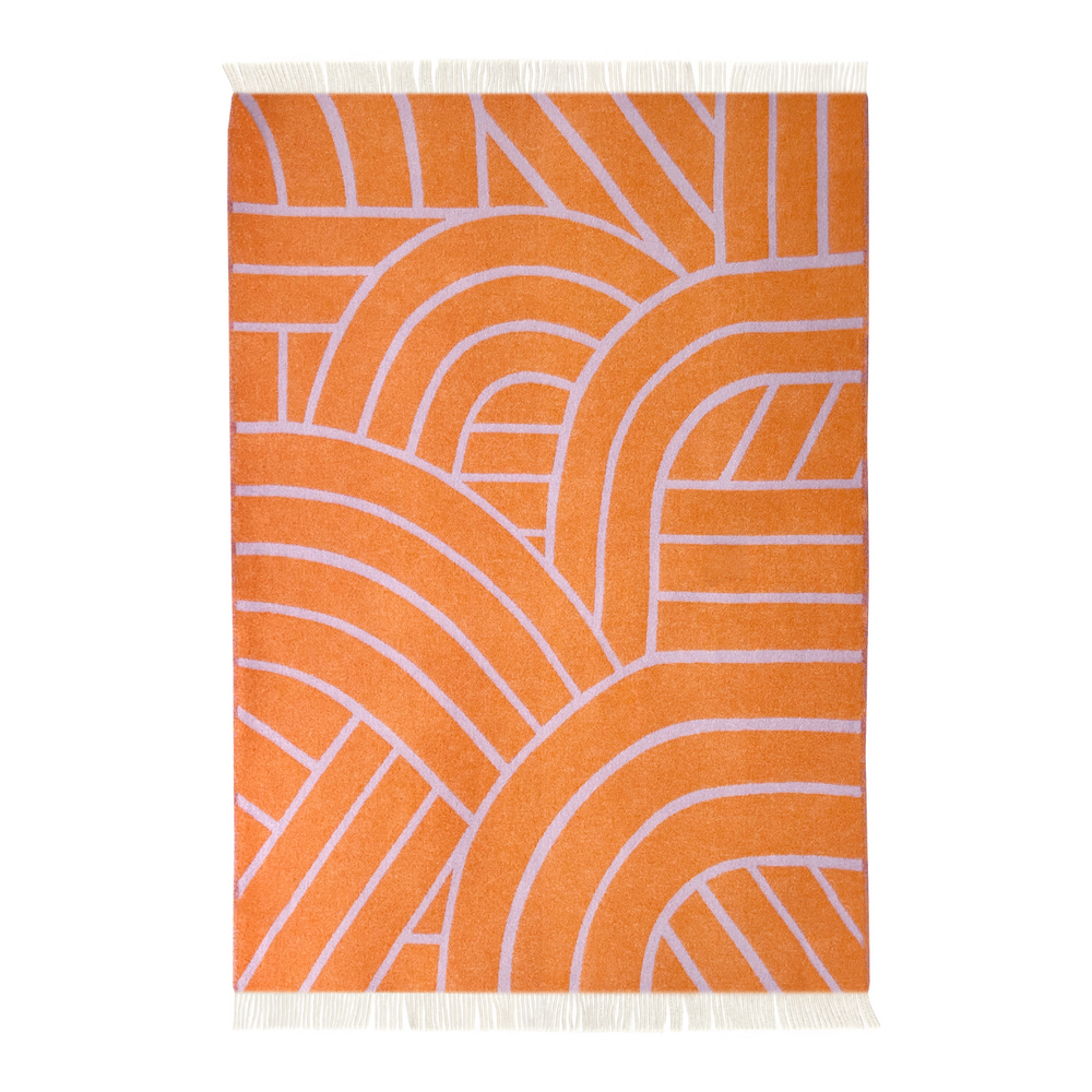 Unfolded wool blanket in a "lines" design and fringe edge, orange side.