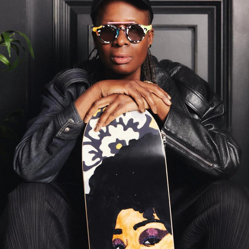
                  
                    Thomas holding the Tres Belle Negresse skateboard wall art.
                  
                
