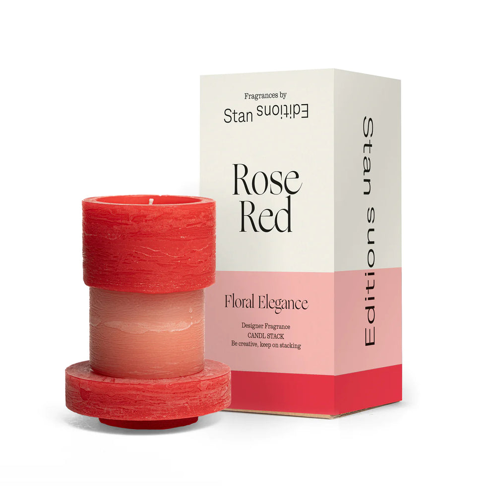 
                      
                        A red and pink 3-layered stacked candle next to box packaging.
                      
                    