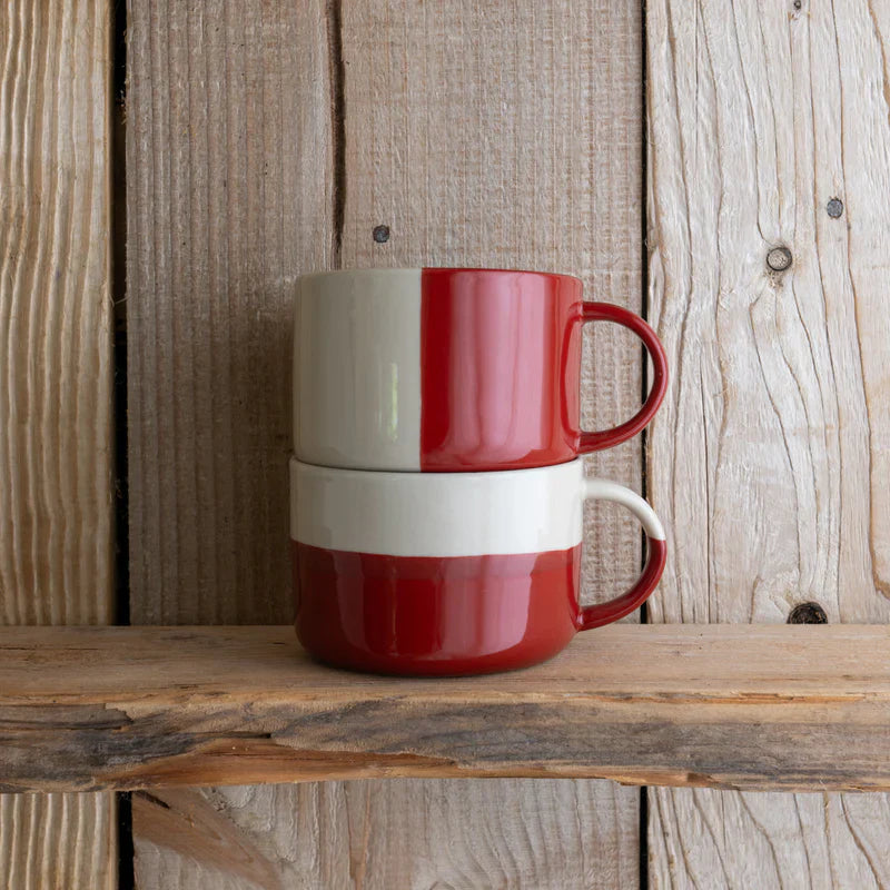 Mugs stacked against a wooden background