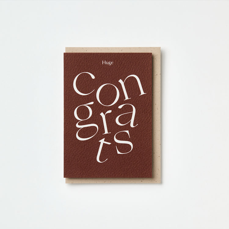 Burgundy greeting card with 'Huge Congrats' text on a white background