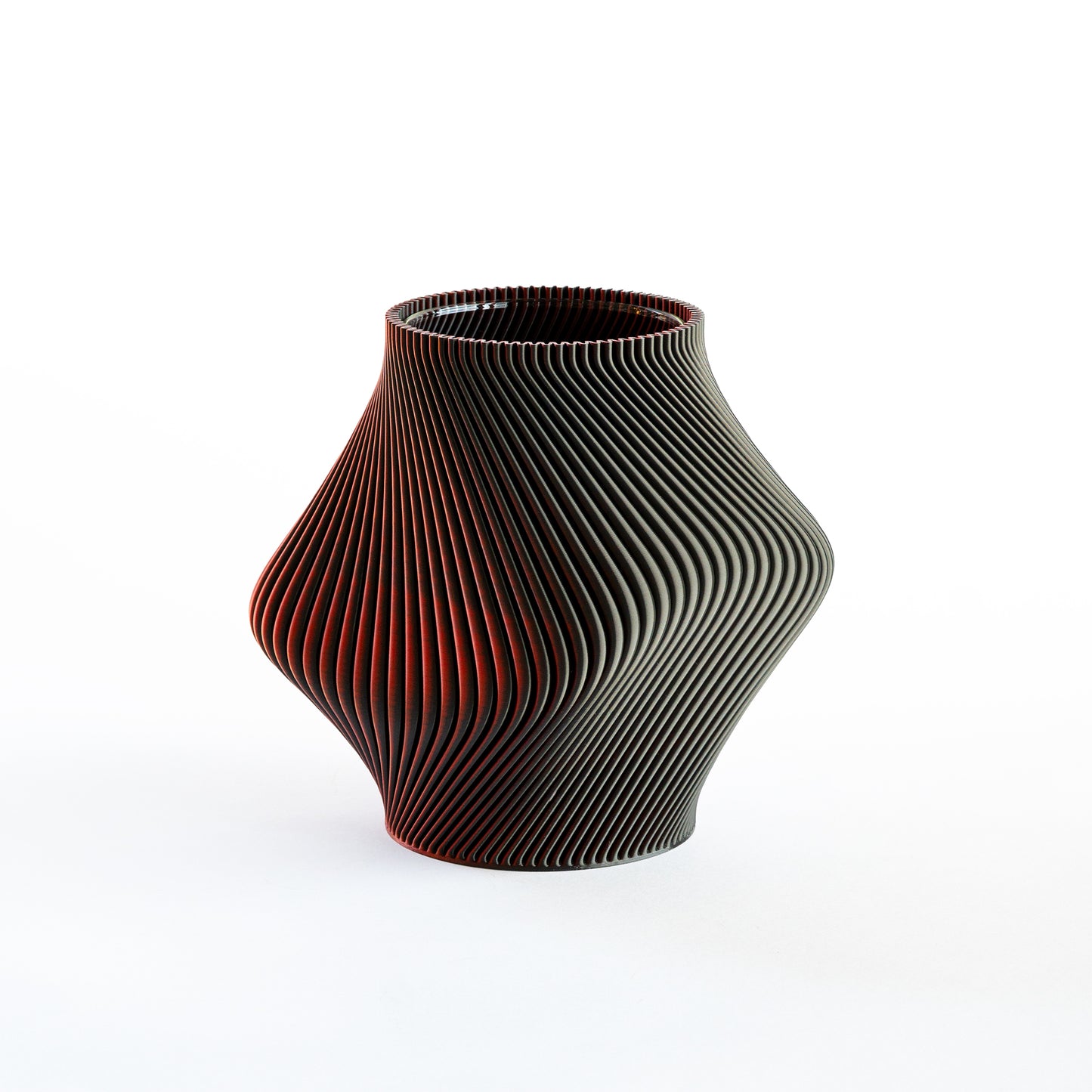 Black and red textured vase on a white background