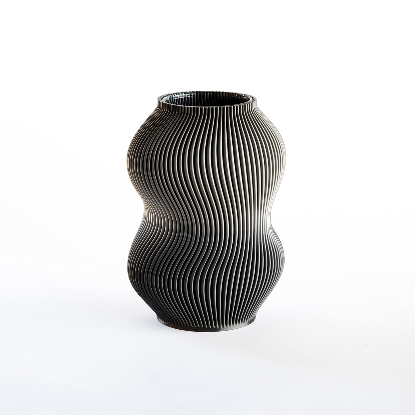 Black textured vase on a white background