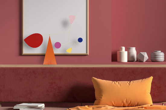 An decorative abstract mobile in a bedroom setting.