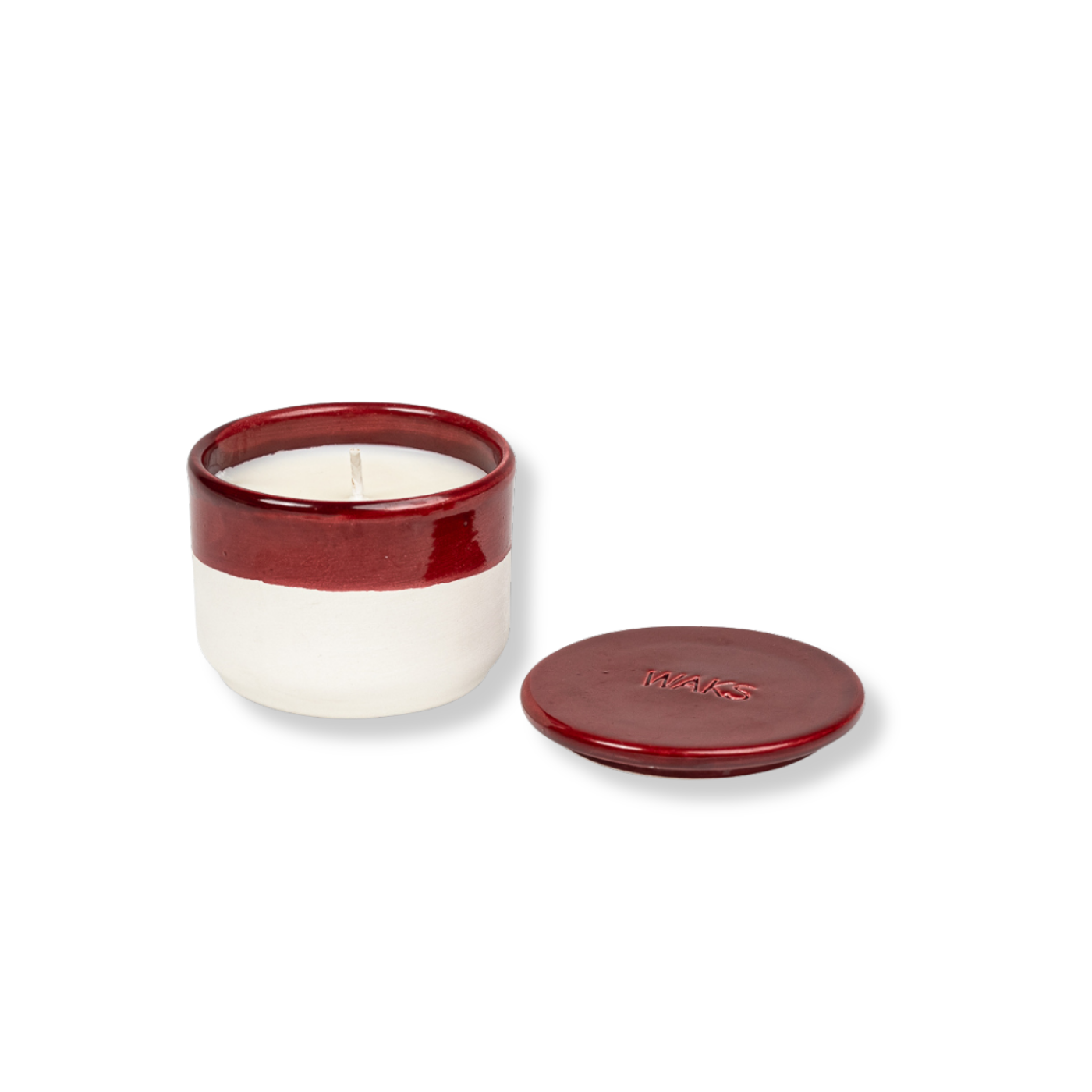 Ceramic candle with red and white design on a white background