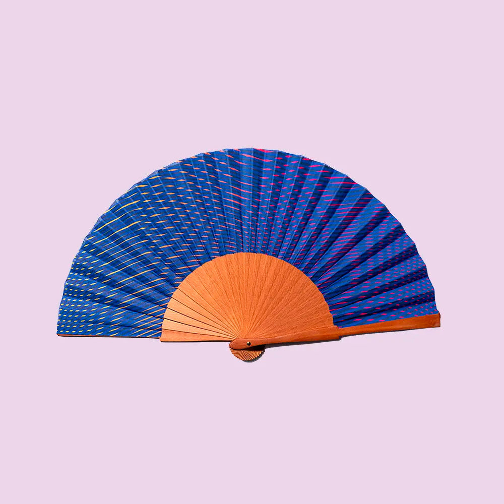 Handheld fan with blue and brown design on a light purple background