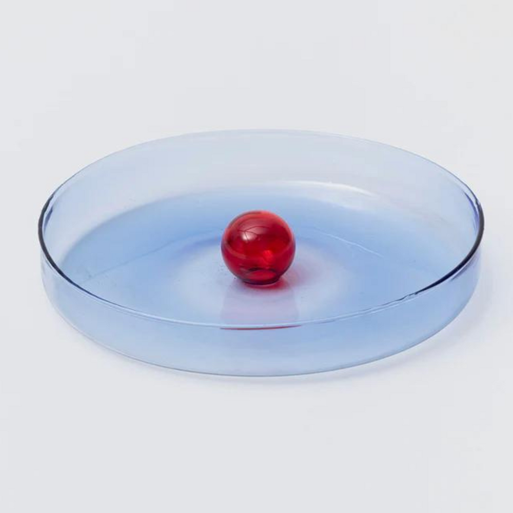 blue glass dish with red bubble ornament in the centre.