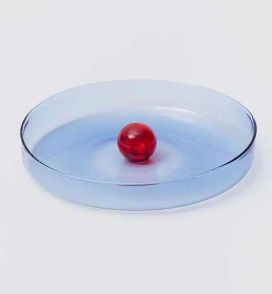 blue glass dish with red bubble ornament in the centre.