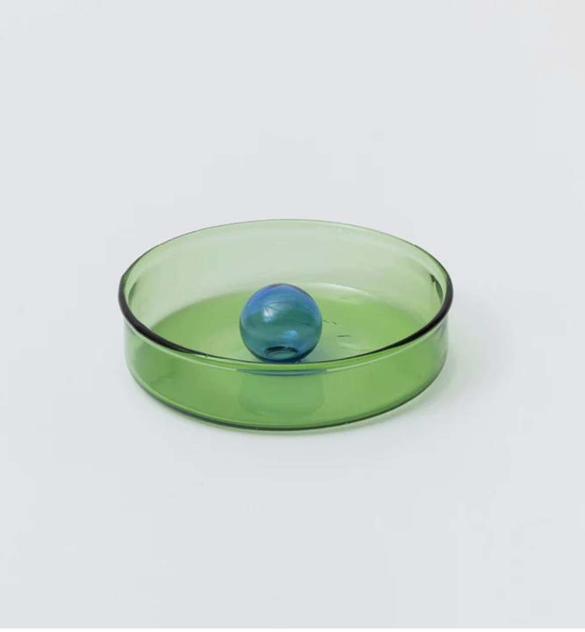 glass green dish with blue bubble ornament in the centre.