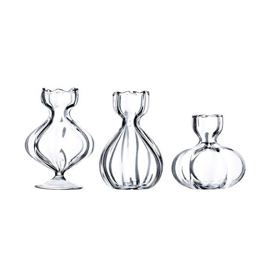 three mini glass vases in assorted shapes.