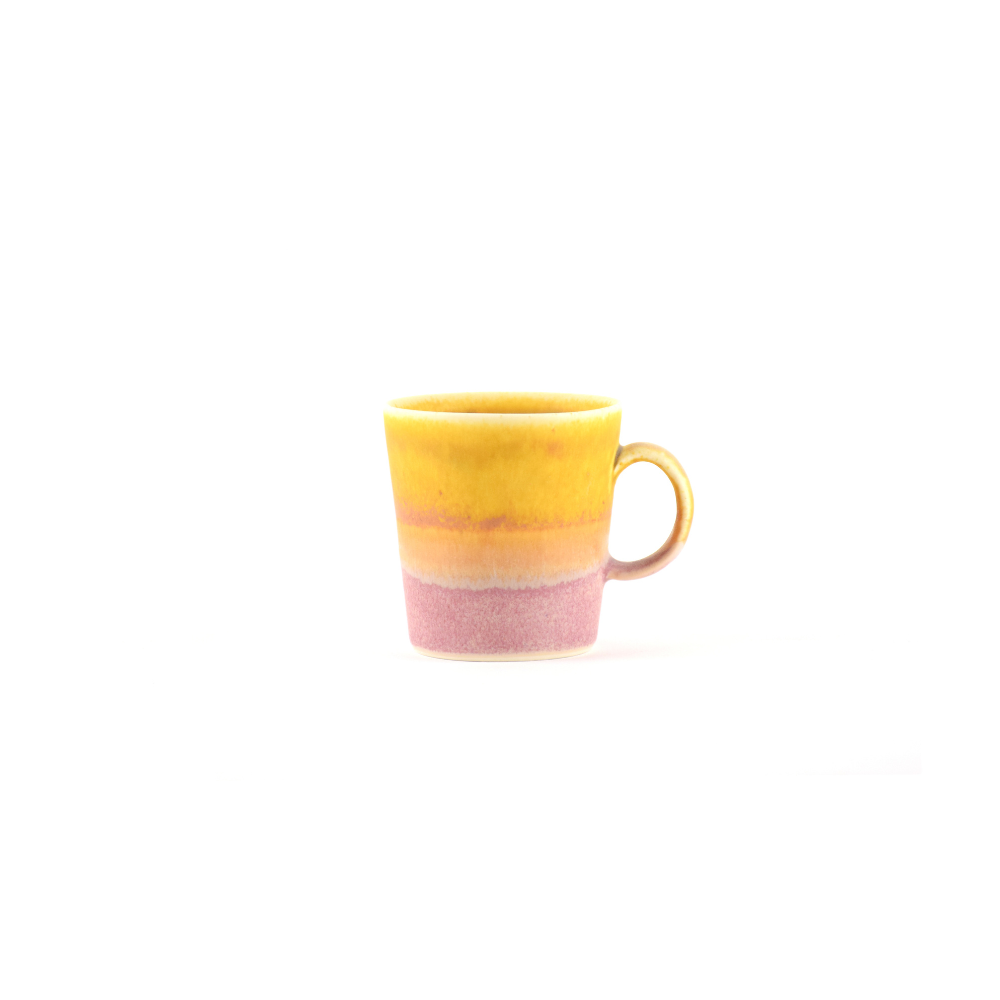 Yellow and pink ceramic mug on a white background
