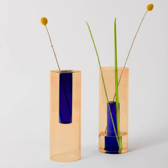 reversible tall vase in peach and cobalt with flower stems.