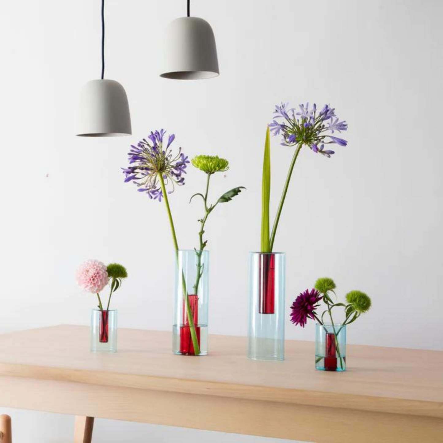 red and blue reversible glass vase in varing sizes.